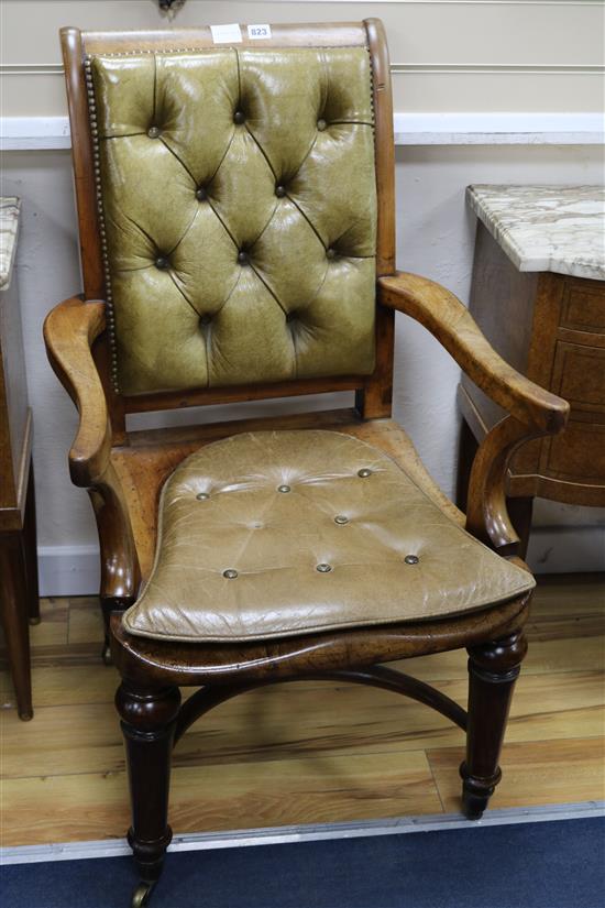A Victorian mahogany desk chair, with an olive green leather buttoned upholstered back